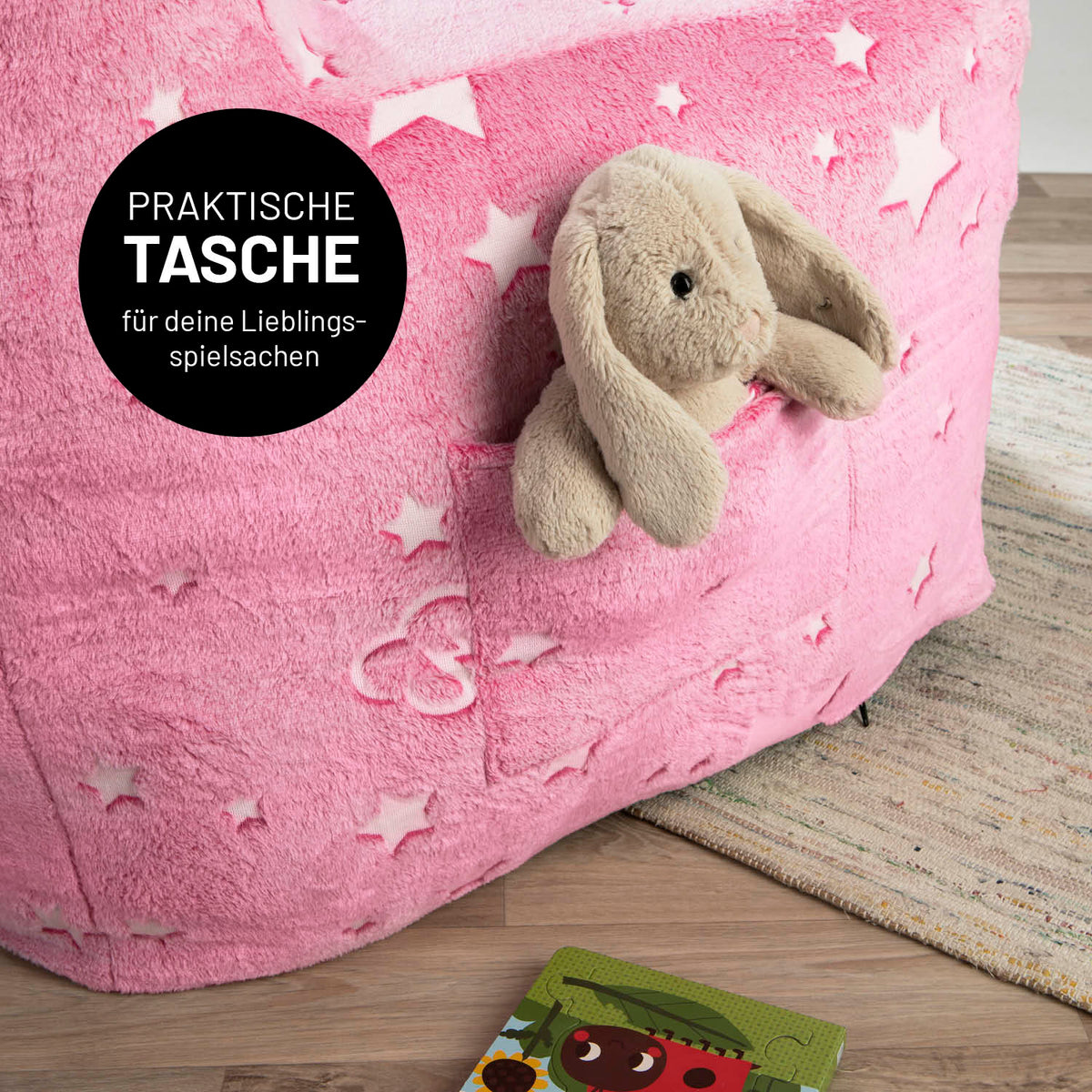 Sessel „Glow in the Dark“ - Pink mit praktischem Fach für Spielzeug und verspieltem Sternen-Design, das im Dunkeln leuchtet.