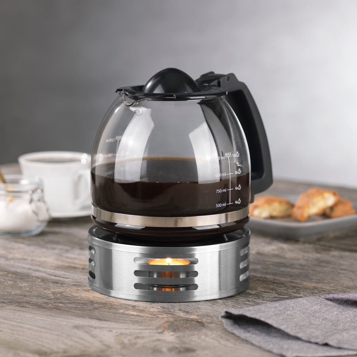 STÖVCHEN Kannenwärmer - Edelstahl hält Kaffee warm, mit Teelichthalter, mattiertem Edelstahl und seitlicher Öffnung für einfaches Teelichtwechseln.