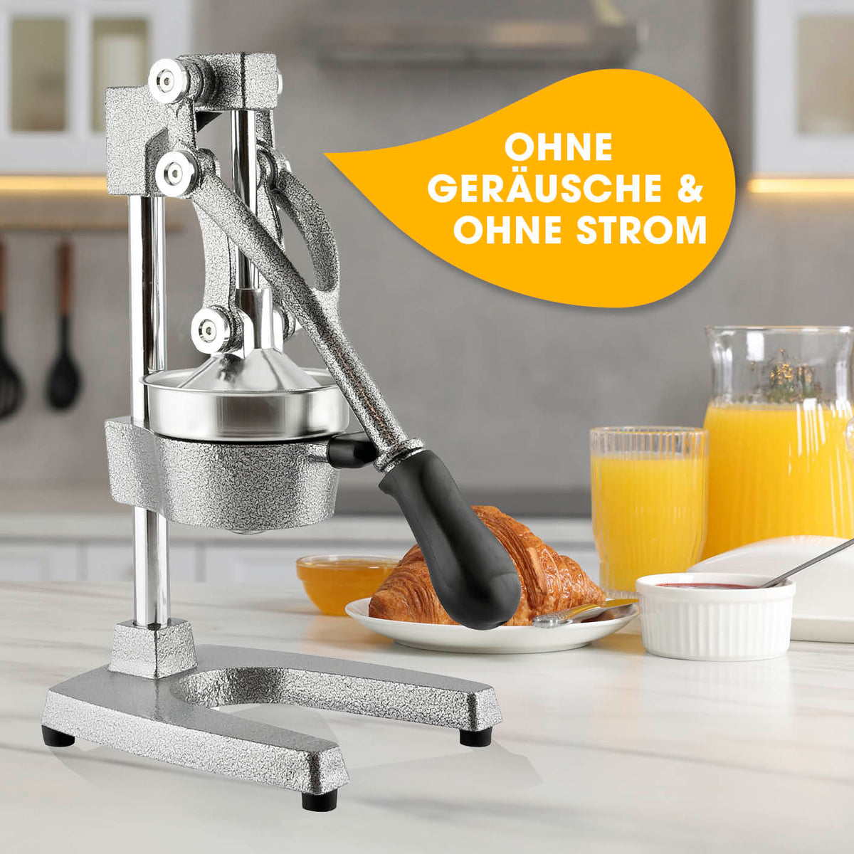 Manuelle Saftpresse + Orangenständer - Silber mit Hebelwirkung für leises Entsaften direkt ins Glas, robust und pflegeleicht.