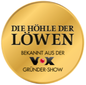 Goldenes Siegel mit der Aufschrift „Die Höhle der Löwen – Bekannt aus der VOX Gründer-Show“, schwarz auf glänzendem Hintergrund.